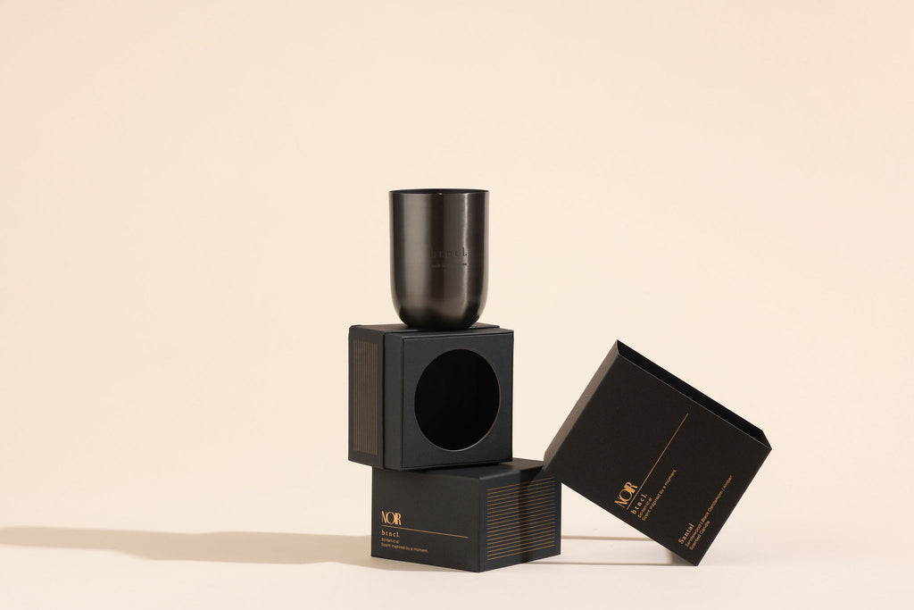 Black candle on boxes stacked