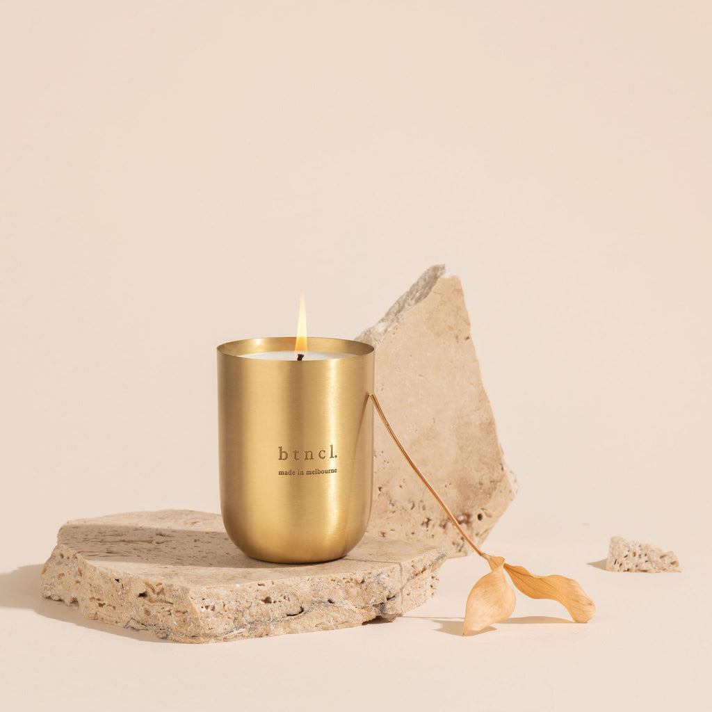 Brass vessel candle on travertine slabs