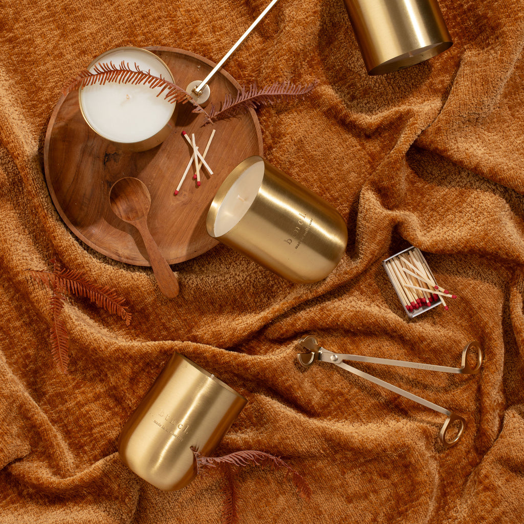 btncl candle and candle accessories on warm neutral velvet