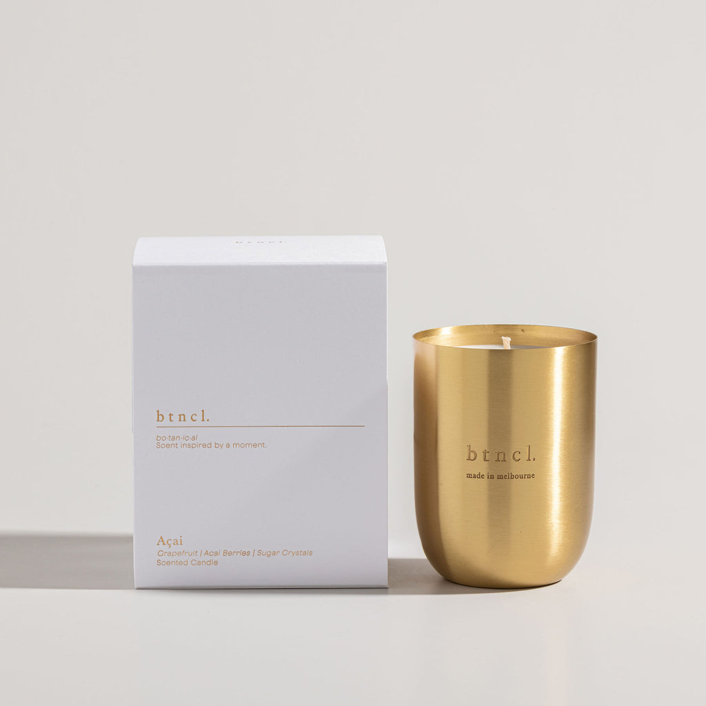 Brass candle next to white packaging