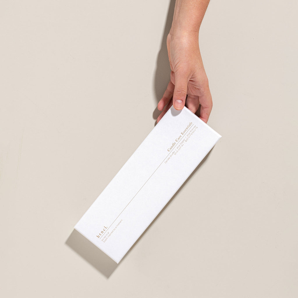 Candle care essentials packaging held in hand